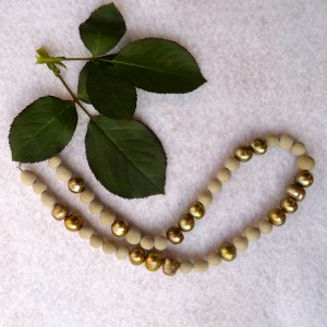 Modern method rose bead necklace with gold pearls.